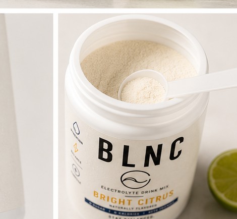 Open BLNC jar with a level scoop of drink mix.